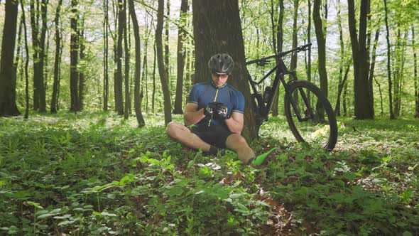 A Cyclist is Viewing Social Networks on His Smartphone