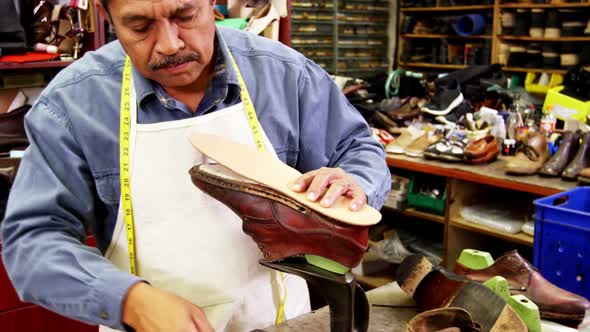 Cobbler working on shoe sole