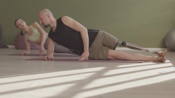 Man with Prosthetic Leg Practicing Yoga in Studio