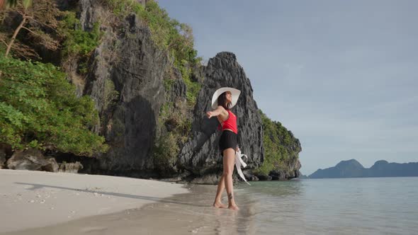 Woman Standing On Shore Of Entalula Beach