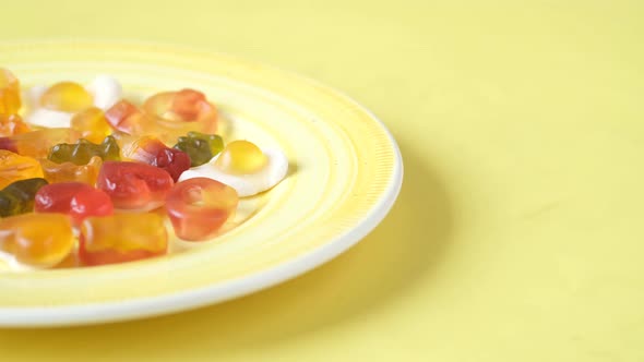 Gummy Candies on a Plate on Yellow Background