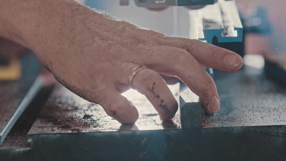 Carpentry Works  Worker Slowly Cutting Along the Small Wooden Detail with a Small Automatic Saw