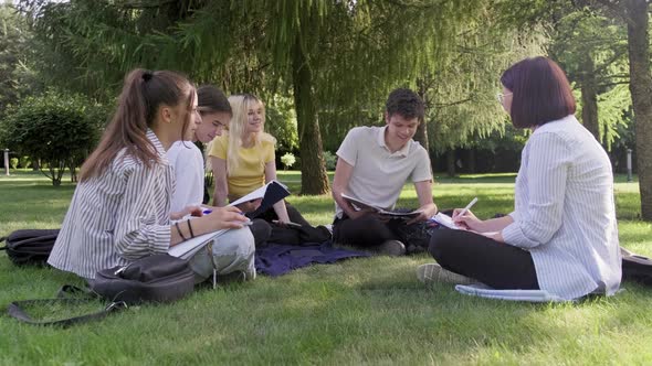 Outdoor Group of Students with Female Teacher