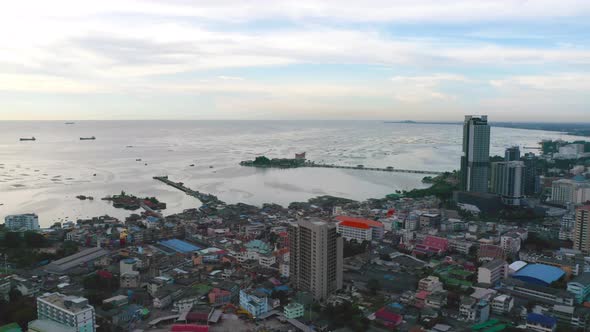 Aerial view of residential buildings in Sri Racha district with sea, Chonburi