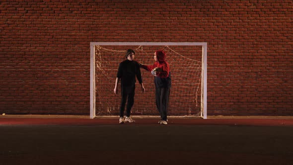 Two Young Men Friends on the Football Playground alt