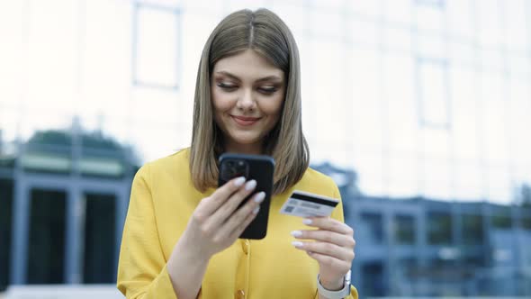 Caucasian Woman is Entering Credit Card Number for Online Shopping Using Mobile Phone