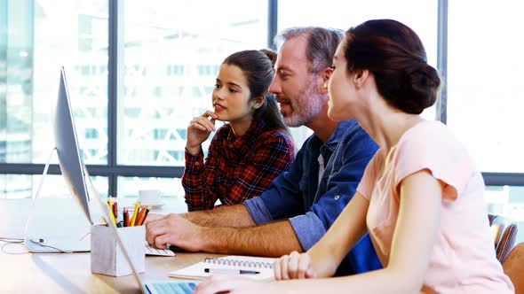 Group of executives working together at desk