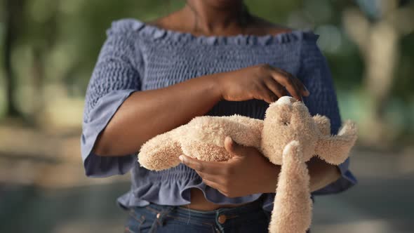 Toy Rabbit in Female African American Hands Outdoors