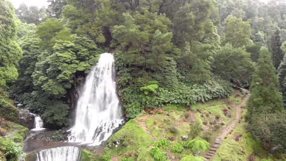 Beautiful waterfall and cascade surrounded by luxuriant vegetation , Azores, Portugal