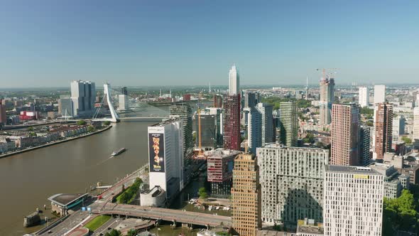 Contemporary Buildings On The Bank Of Nieuwe Maas River In Rotterdam, Netherlands. Erasmusbrug Bridg