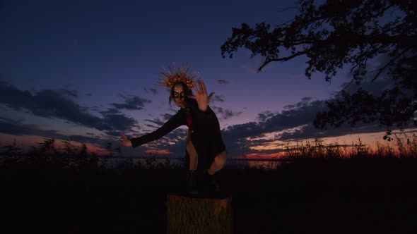 Happy Young Woman in Halloween Costume and Makeup Dances in Nature During Sunset Mystical Footage