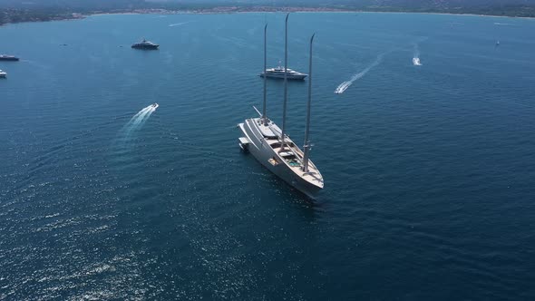 Aerial view of a yacht and many boats along the coast, France.