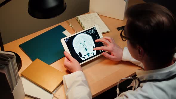 Doctor Examining Blood Vessels Xray on Gadget Tablet