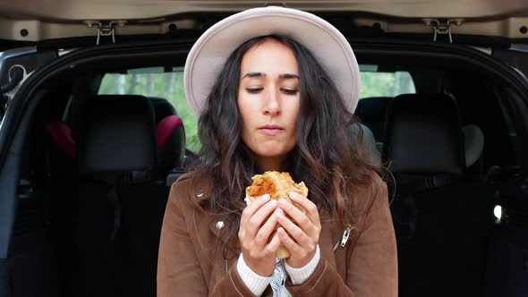 Women eating a sandwich in nature. Snack in nature.