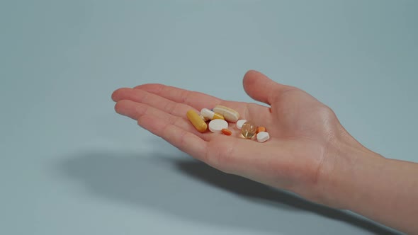 Handful of tablets and capsules of various shape