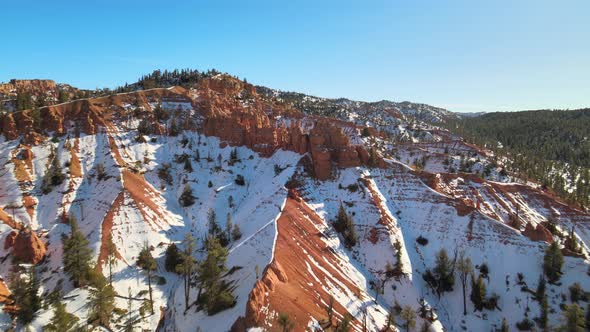 Aerial views of snow-covered sandstone formations of the Red Canyon and the Dixie National Forest ne