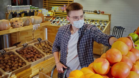 Male Customer is Buying Grapefruit in Supermarket Face Mask for Protection From Covid19