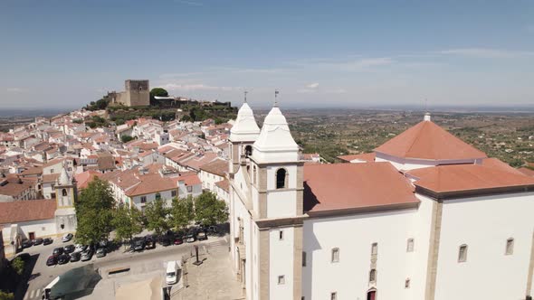Santa Maria da Devesa church and old castle in background, Castelo de Vide in Portugal. Aerial view