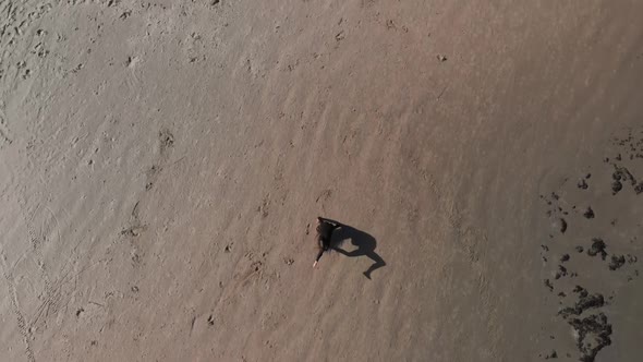 Aerial Pretty Gymnast Woman Practices Back Handspring on Sandy Beach