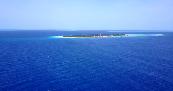 Wide fly over clean view of a sunshine white sandy paradise beach and turquoise sea background in co