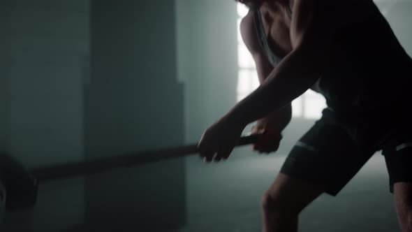 Powerful Athlete Exercising with Sledgehammer