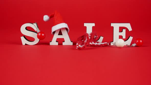 White Letters SALE Decorated with Christmas Hat, Warm Scarf and Tree Ball. Stop Motion