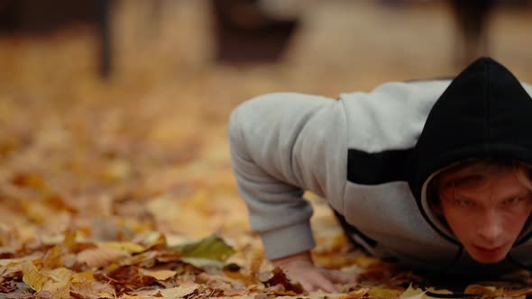 Man Pushups Outdoor at the Autumn Park