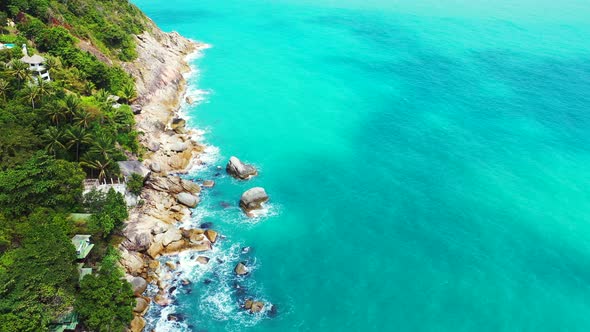 Wide fly over tourism shot of a white paradise beach and blue sea background 