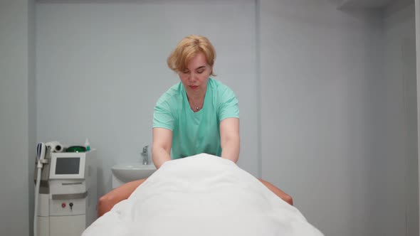 Adult Woman Masseur Makes Therapeutic Back Massage Beautiful Girl in Spa Salon