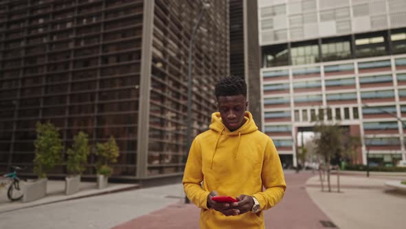 African American Man in a Downtown City Center Chatting with Cellphone