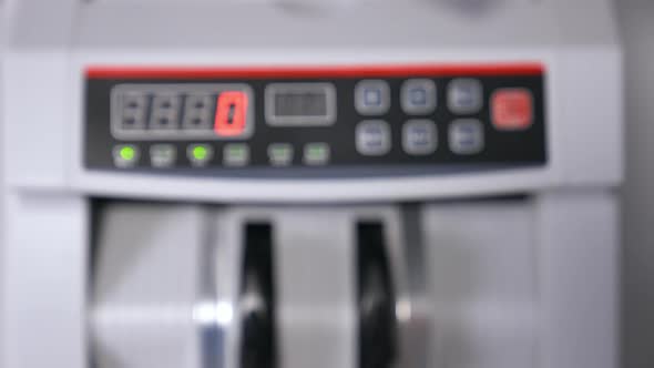 Modern electronic bill counter with money, closeup