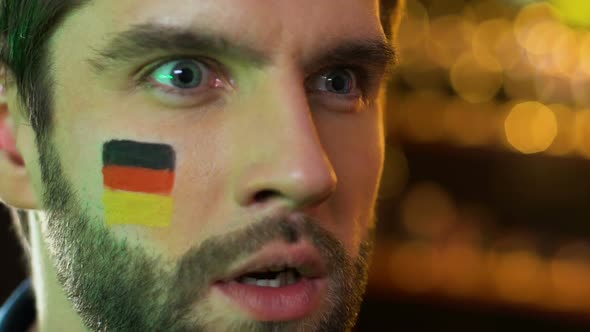 Male Fan With German Flag on Cheek Upset About Favorite Sports Team Losing Game