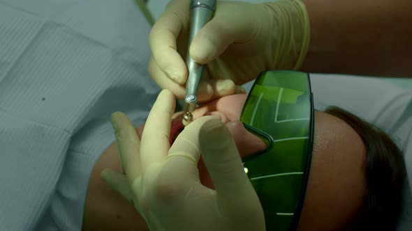 Dentist Brushes Girls Teeth with Electric Brush