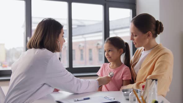 Mother Girl and Doctor with Stethoscope at Clinic