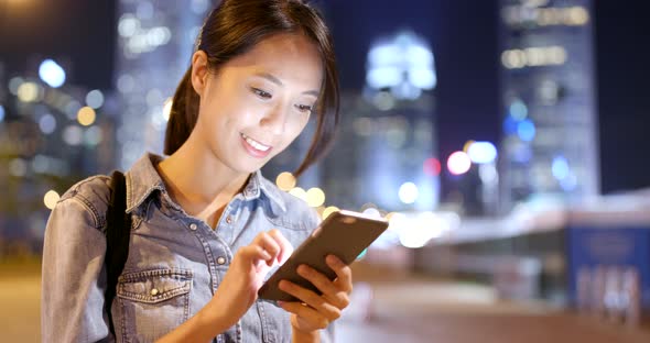 Woman use of smart phone at night 