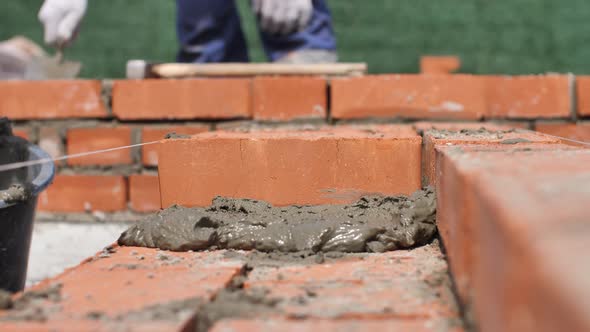 Industrial Bricklayers Installing Brick on Construction Site