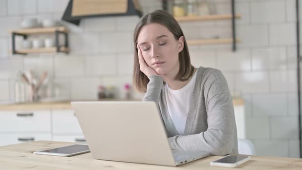 Young Woman Having Quick Nap on Office Desk