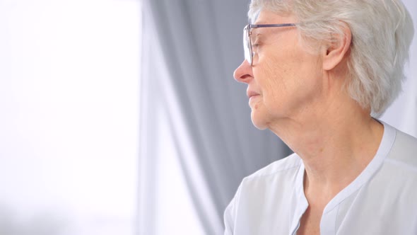 Thoughtful old woman with short grey hair