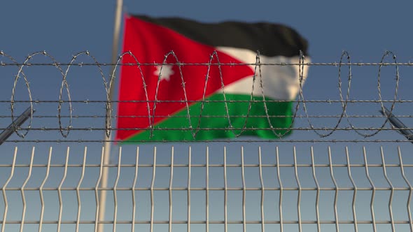 Barbed Wire Against Waving Flag of Jordan