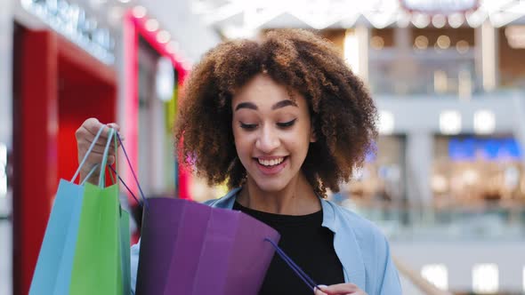 African American Young Girl Curly Hair Woman Shopper Consumer Buyer Client in Shopping Mall Opens