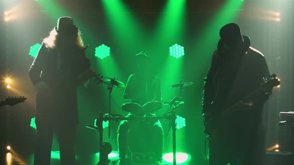 Rock Musicians Perform Live in Original Irish Costumes and Hats in Dark Smoky Studio with Green