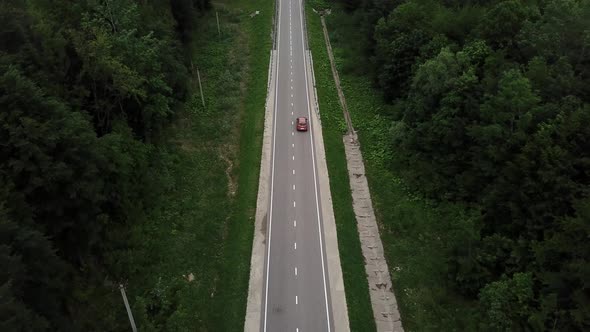 Drone Point of View Tracking Mode Aerial View Flying Over Two Lane Countryside Forest Road with