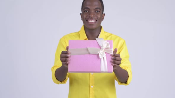 Young Happy African Businessman Giving Gift Box