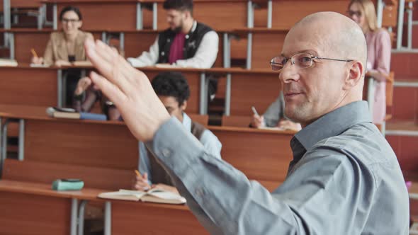 Confident Professor Talking to Students Giving Lecture