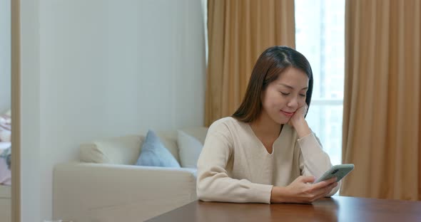 Woman use cellphone online at home