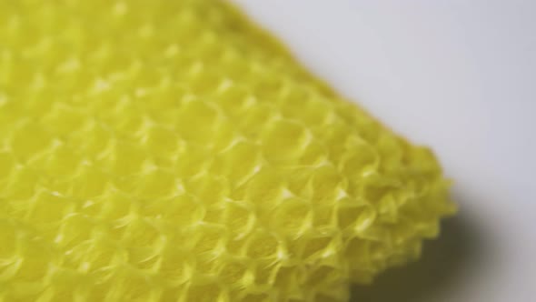 Yellow Loofah for Utensils Cleaning on White Surface