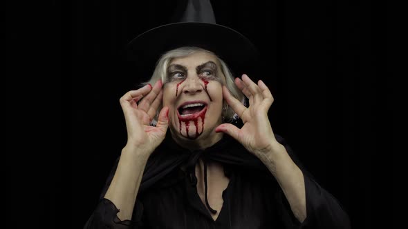 Old Witch Halloween Makeup. Elderly Woman Portrait with Blood on Her Face