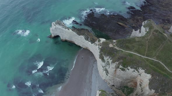 Wide Establishing Shot of Cliff Shoreline and Ruff Ocean Waves, Etretat Cliffs in France