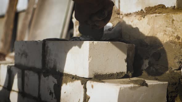 Construction Worker or Mason Laying Bricks and Creating Walls. Bricklayer Laying Bricks To Make a