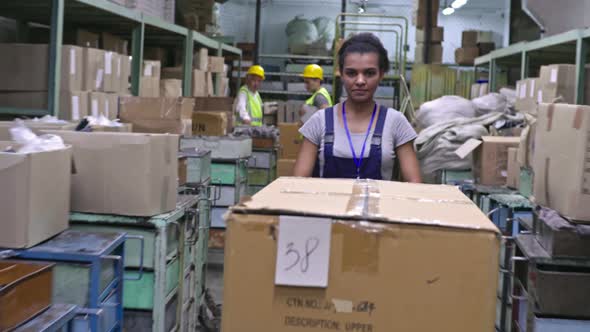 Female Factory Worker with Warehouse Trolley